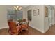 Bright breakfast nook features stylish chandelier, glass table, wicker chairs and wood floors at 12229 Stuart Dr, Venice, FL 34293