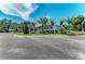 Gorgeous community clubhouse featuring palm trees, manicured landscaping, and gorgeous architecture at 12229 Stuart Dr, Venice, FL 34293