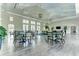Bright clubhouse features hardwood floors, dining tables, lounge areas and plenty of natural light at 12229 Stuart Dr, Venice, FL 34293