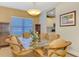 Formal dining room offers a glass table, stylish light fixture and decorative rug at 12229 Stuart Dr, Venice, FL 34293