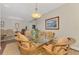 The dining room offers a glass table, stylish light fixture and decorative rug at 12229 Stuart Dr, Venice, FL 34293