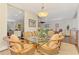 The dining room offers a glass table, stylish light fixture and decorative rug at 12229 Stuart Dr, Venice, FL 34293