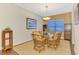 Formal dining room offers a glass table, stylish light fixture and decorative rug at 12229 Stuart Dr, Venice, FL 34293