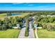 Grand Palm gated entrance showcases lush landscaping, palm trees, and a serene lake view, creating an inviting community welcome at 12229 Stuart Dr, Venice, FL 34293