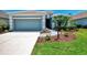 Inviting home with a two-car garage, complemented by verdant landscaping and a winding walkway at 12229 Stuart Dr, Venice, FL 34293