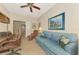 Comfortable home office provides a sofa, ceiling fan, and large desk at 12229 Stuart Dr, Venice, FL 34293