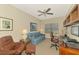 Comfortable home office provides a sofa, ceiling fan, and built-in shelving at 12229 Stuart Dr, Venice, FL 34293