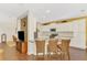 Bright kitchen with white cabinets, granite countertops, mosaic backsplash, and three wicker stools at 12229 Stuart Dr, Venice, FL 34293