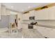 Well-lit kitchen featuring white cabinets, stainless steel appliances, and granite countertops at 12229 Stuart Dr, Venice, FL 34293