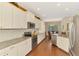 Modern kitchen featuring stainless steel appliances, white cabinets, and granite countertops at 12229 Stuart Dr, Venice, FL 34293