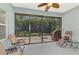 Relaxing screened patio features a ceiling fan and comfortable seating, perfect for enjoying the outdoors at 12229 Stuart Dr, Venice, FL 34293