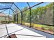 Screened in lanai with ample space and clear views of the tropical landscaping, a perfect place to relax at 12229 Stuart Dr, Venice, FL 34293