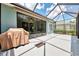 Enclosed patio with BBQ, screen cage, and ample sunlight offers a serene space for outdoor relaxation and entertainment at 12229 Stuart Dr, Venice, FL 34293