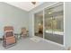 Screened patio features sliding doors and neutral colors; perfect for relaxing and enjoying the outdoors at 12229 Stuart Dr, Venice, FL 34293