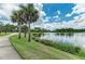 Beautiful pond view with lush landscaping and palm trees at 12229 Stuart Dr, Venice, FL 34293