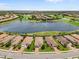 Beautiful aerial view of a neighborhood, showcasing waterfront homes near a golf course and lake at 12856 Sorrento Way, Bradenton, FL 34211