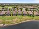 Scenic aerial view of waterfront homes featuring screened-in pools and well-manicured lawns at 12856 Sorrento Way, Bradenton, FL 34211
