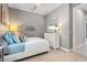 Bright bedroom with nautical decor, a cozy bed, and a dresser with a TV for relaxation at 12856 Sorrento Way, Bradenton, FL 34211
