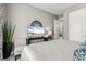 Serene bedroom with a sleek TV, soothing decor, and an open doorway leading to another room at 12856 Sorrento Way, Bradenton, FL 34211