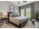 Comfortable bedroom featuring stylish decor, patterned curtains, and bright natural light from the window at 12856 Sorrento Way, Bradenton, FL 34211