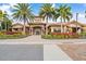 Charming building with a tile roof, surrounded by beautiful landscaping and a well-paved walkway at 12856 Sorrento Way, Bradenton, FL 34211