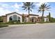 Elegant clubhouse with stone accents, arched windows, lush landscaping, and a welcoming entrance at 12856 Sorrento Way, Bradenton, FL 34211