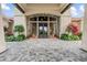 Grand entrance with beautiful stone work and lush landscaping, creating a welcoming atmosphere at 12856 Sorrento Way, Bradenton, FL 34211