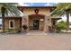 Charming building entrance adorned with a festive wreath and lush landscaping, exuding curb appeal at 12856 Sorrento Way, Bradenton, FL 34211
