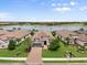 Charming home with a brick driveway, lush landscaping, and a view of the lake and golf course at 12856 Sorrento Way, Bradenton, FL 34211
