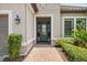 Charming front entrance with a brick pathway, manicured landscaping, and a welcoming glass-paneled door at 12856 Sorrento Way, Bradenton, FL 34211
