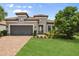 Charming single-story home featuring a tile roof, brick driveway, and a well-manicured front yard at 12856 Sorrento Way, Bradenton, FL 34211