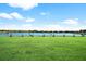 Picturesque golf course driving range on a sunny day, backing onto a serene lake and residences at 12856 Sorrento Way, Bradenton, FL 34211