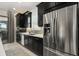 Modern kitchen featuring stainless steel appliances and dark cabinets at 12856 Sorrento Way, Bradenton, FL 34211