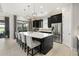 Gourmet kitchen featuring a large island, modern appliances, and elegant black cabinetry at 12856 Sorrento Way, Bradenton, FL 34211