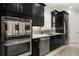 Modern kitchen featuring stainless steel appliances and dark cabinets at 12856 Sorrento Way, Bradenton, FL 34211