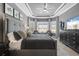 Elegant main bedroom with tray ceilings, bay windows, and a serene gray color palette at 12856 Sorrento Way, Bradenton, FL 34211