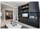 Modern office with built-in dark wood cabinets and shelving, open to the dining room at 12856 Sorrento Way, Bradenton, FL 34211