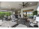 Covered lanai with multiple seating areas, an outdoor kitchen, and views of the pool at 12856 Sorrento Way, Bradenton, FL 34211