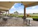 Outdoor patio with comfortable seating overlooking a lush green lawn, perfect for relaxation at 12856 Sorrento Way, Bradenton, FL 34211