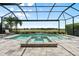 Large screened-in pool and spa with lush landscaping and serene lake view at 12856 Sorrento Way, Bradenton, FL 34211