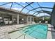 Beautiful screened-in pool with spa and lake view, perfect for relaxation and entertainment at 12856 Sorrento Way, Bradenton, FL 34211