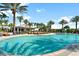 Beautiful pool area featuring palm trees, lounge chairs, and a tropical setting perfect for relaxation at 12856 Sorrento Way, Bradenton, FL 34211