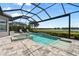 Relaxing screened-in pool and spa area featuring a tranquil lake view at 12856 Sorrento Way, Bradenton, FL 34211