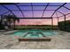 Private screened-in pool and spa overlooking a serene lake, perfect for relaxation and entertainment at 12856 Sorrento Way, Bradenton, FL 34211