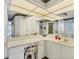 Bright bathroom featuring a makeup vanity, large mirror, and white cabinetry at 1304 Alton Rd, Port Charlotte, FL 33952