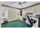 Bedroom with built-in shelving, desk area, a ceiling fan, and green carpeting at 1304 Alton Rd, Port Charlotte, FL 33952