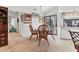 Dining area featuring wicker chairs, carpet floors, and artwork on the walls, adjacent to the kitchen at 1304 Alton Rd, Port Charlotte, FL 33952