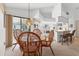 Open concept dining area features a wicker table set with views of the kitchen and living area at 1304 Alton Rd, Port Charlotte, FL 33952