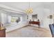 Elegant dining room with chandelier, window seat, and ample natural light at 1304 Alton Rd, Port Charlotte, FL 33952