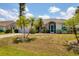 Charming single-story home with well-manicured lawn and tropical landscaping at 1304 Alton Rd, Port Charlotte, FL 33952